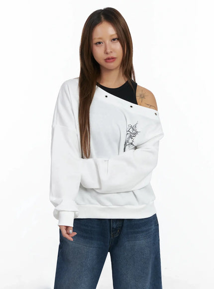 off-shoulder-eyelet-graphic-sweater-in528